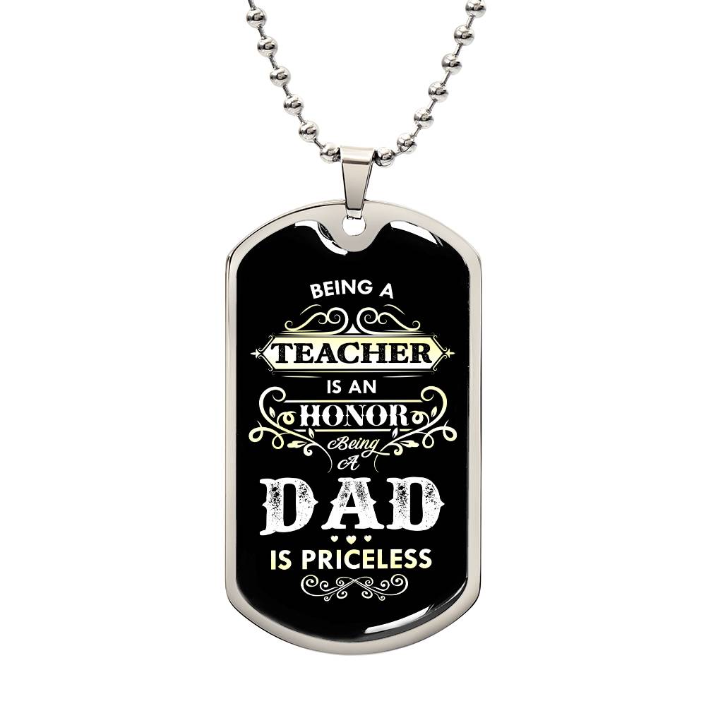 This image showcases a dog tag necklace engraved with the touching message, "Being a teacher is an honor, being a dad, is priceless." Placed on a black background, the necklace radiates warmth and meaning. This piece of jewelry honors the significant roles of both teacher and father, acknowledging the pride and fulfillment found in each. It makes a thoughtful gift for those who dedicate themselves to educating others while cherishing their role as a dad, symbolizing the priceless value of both vocations.