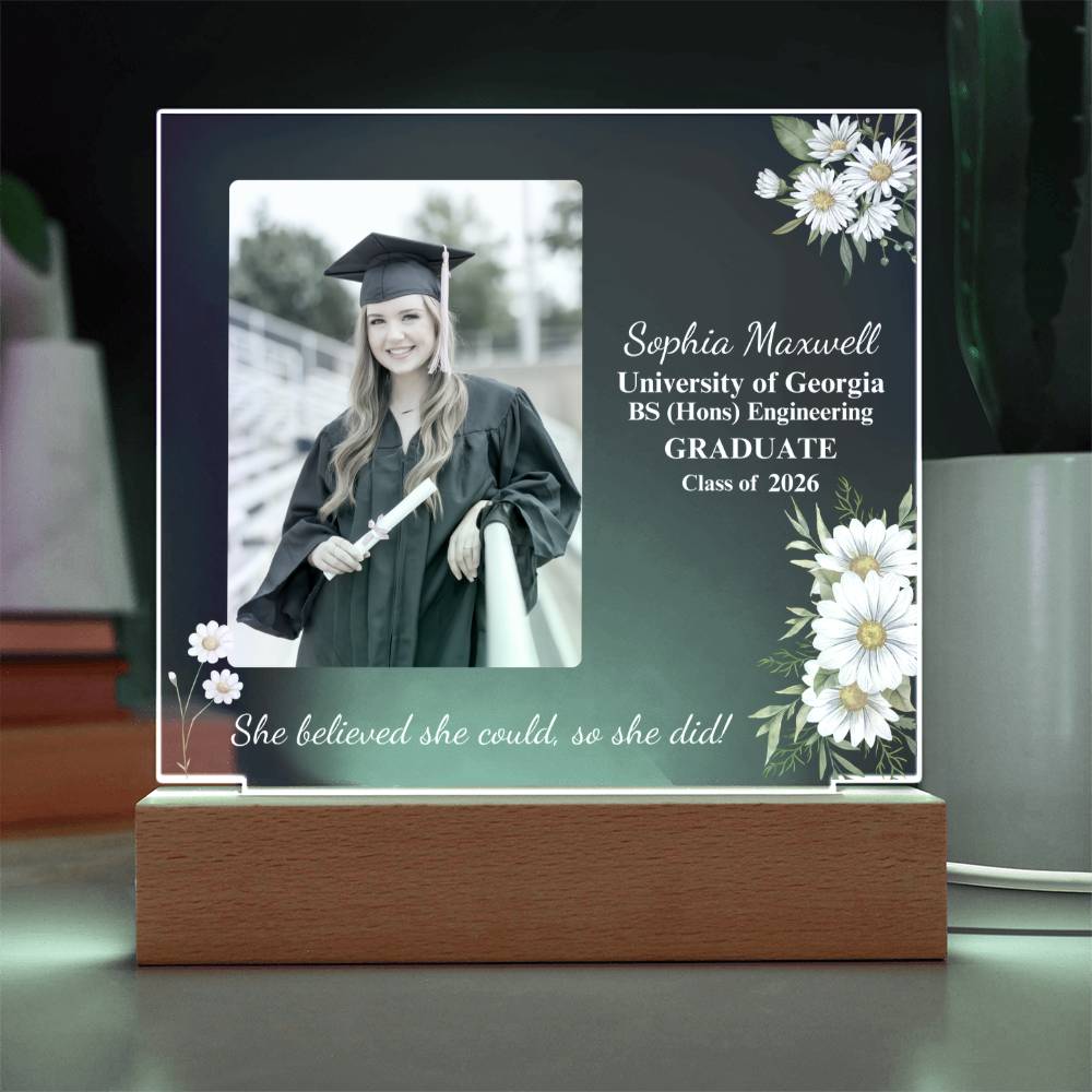 Graduation-themed photo frame with a portrait of a graduate and floral design on a dark background.