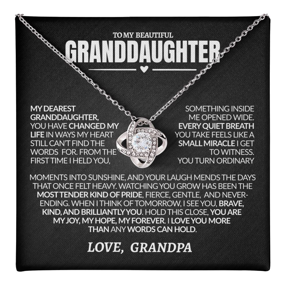 Necklace with heart-shaped pendant on a black card with heartfelt message from Grandpa to granddaughter
