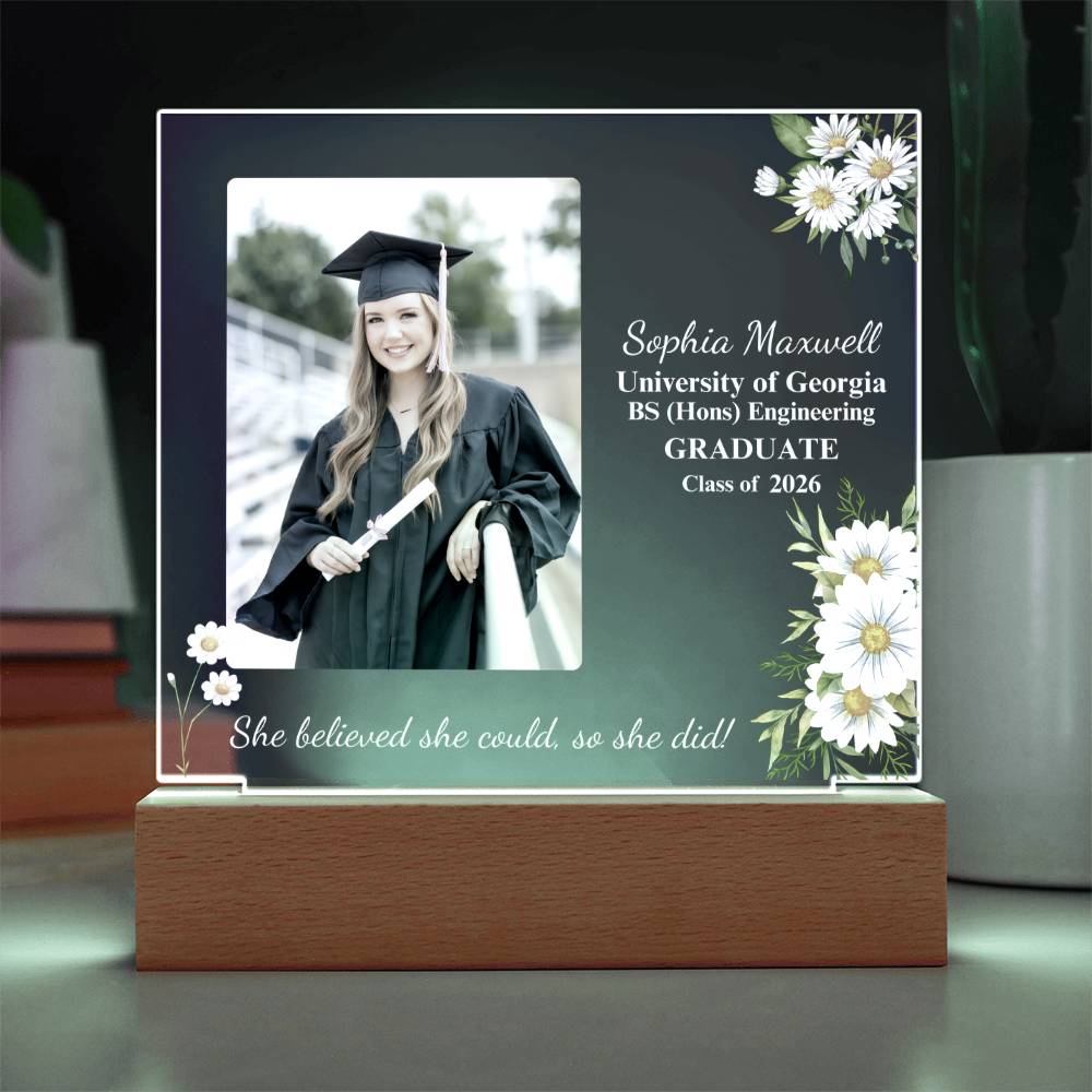 Graduation-themed photo frame with a portrait of a graduate, flowers, and text on a dark background.
