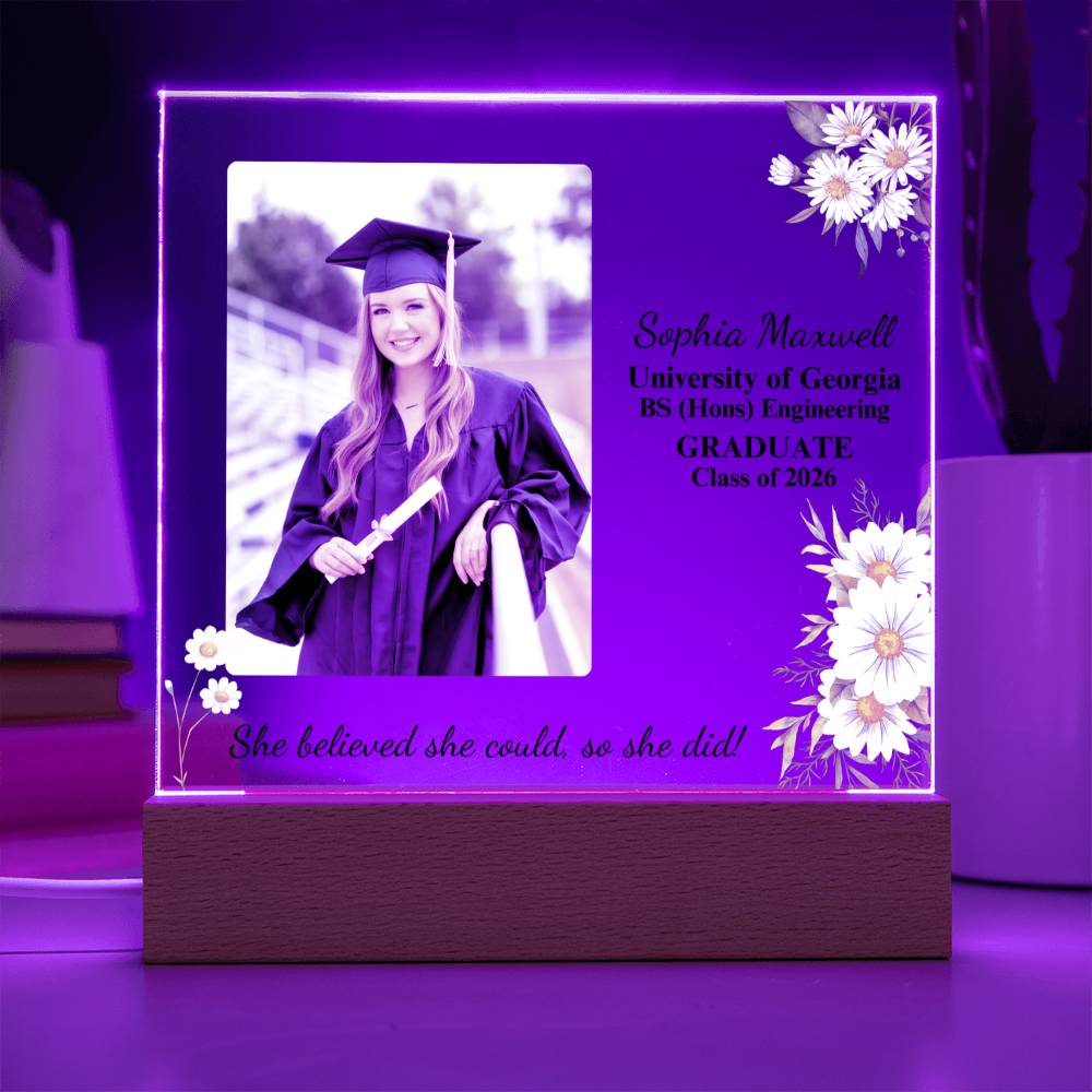 Graduation-themed illuminated photo frame with a photo of a graduate, name, and graduation details on a purple background.
