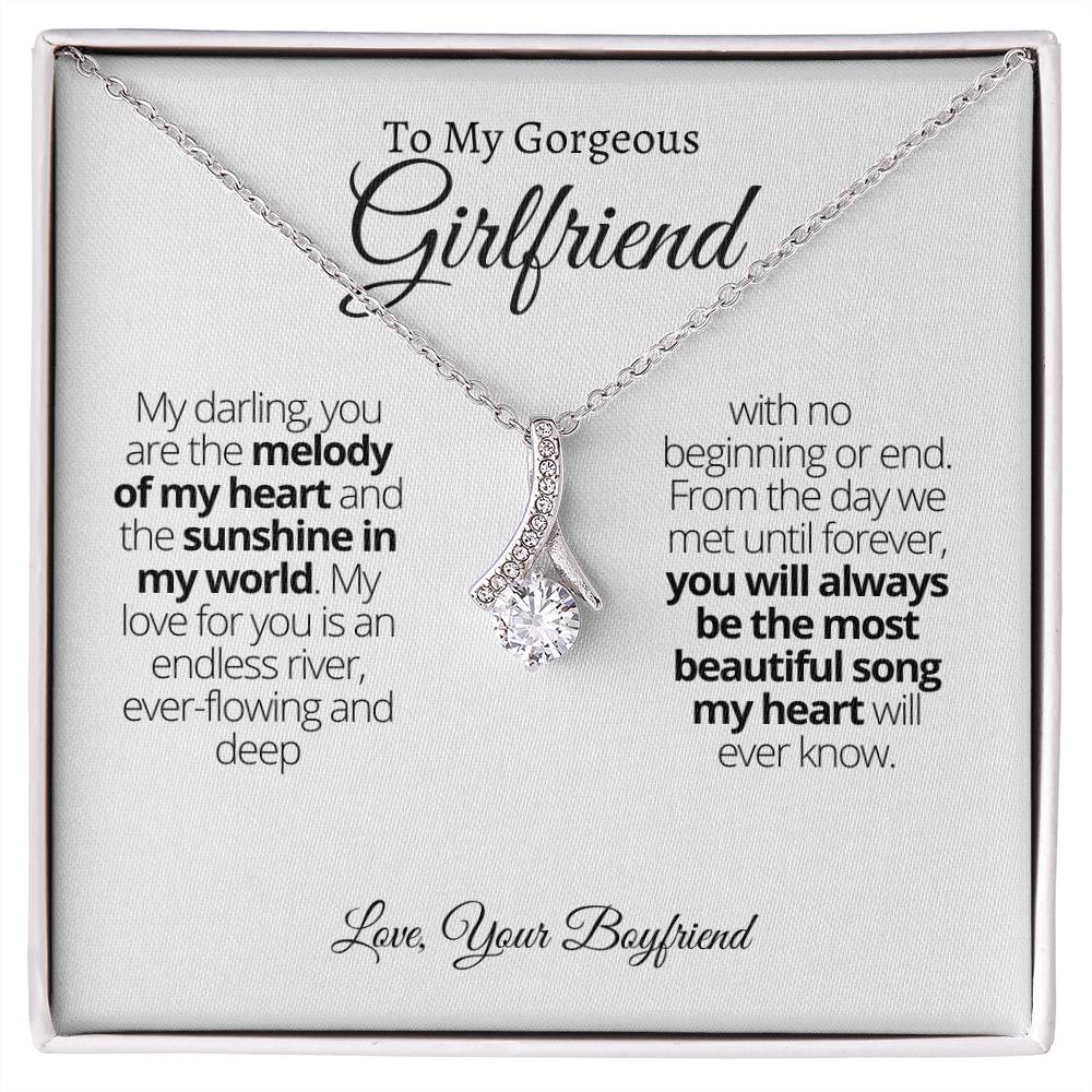 Wow your girl with the Alluring Beauty necklace! Delightfully petite with a ribbon-shaped pendant, it's sure to leave her awestruck. Complementing any outfit, this necklace is perfect for any special occasion, whether it's a birthday or anniversary. Make it a gift she'll never forget and cherish for years to come!