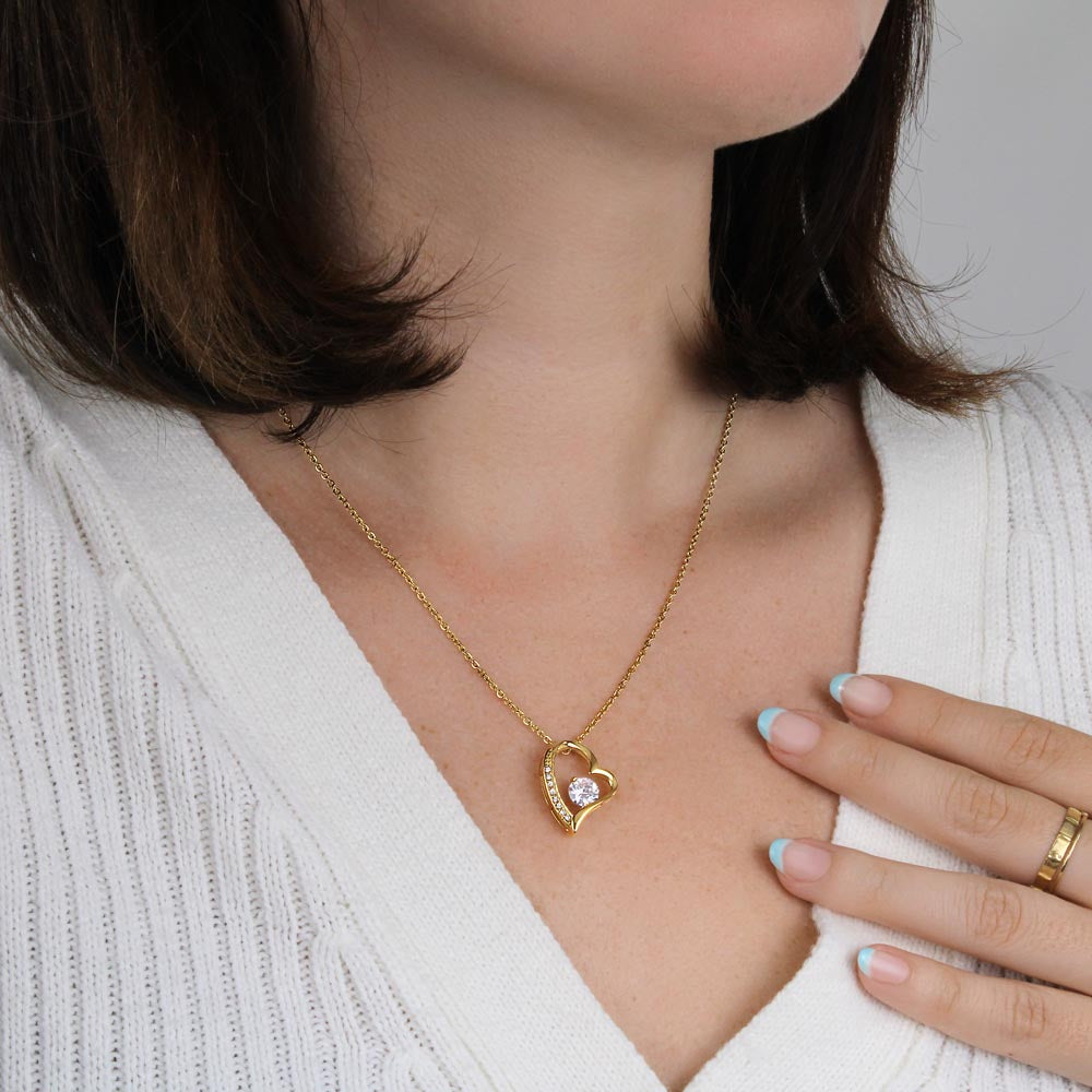 Woman wearing forever heart necklace.