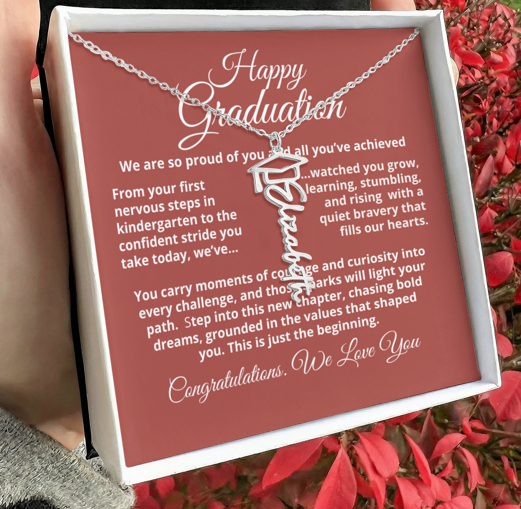 Close-up of personalized Graduation Cap Name Necklace showing scripted nameplate with small cap charm and adjustable cable chain.