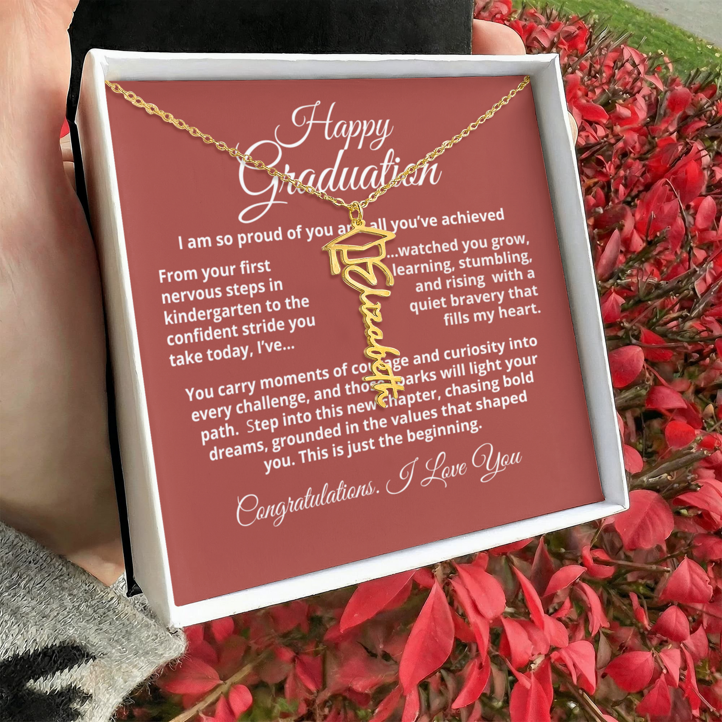 Personalized graduation name necklace with tassel cap charm, signature script nameplate in 18K gold or stainless steel, adjustable 18–20 inch chain.