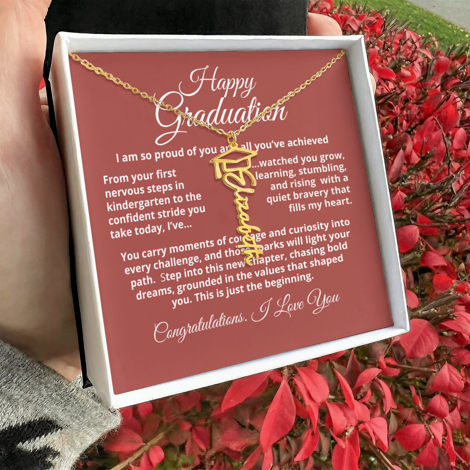 Personalized graduation name necklace with tassel cap charm, signature script nameplate in 18K gold or stainless steel, adjustable 18–20 inch chain.