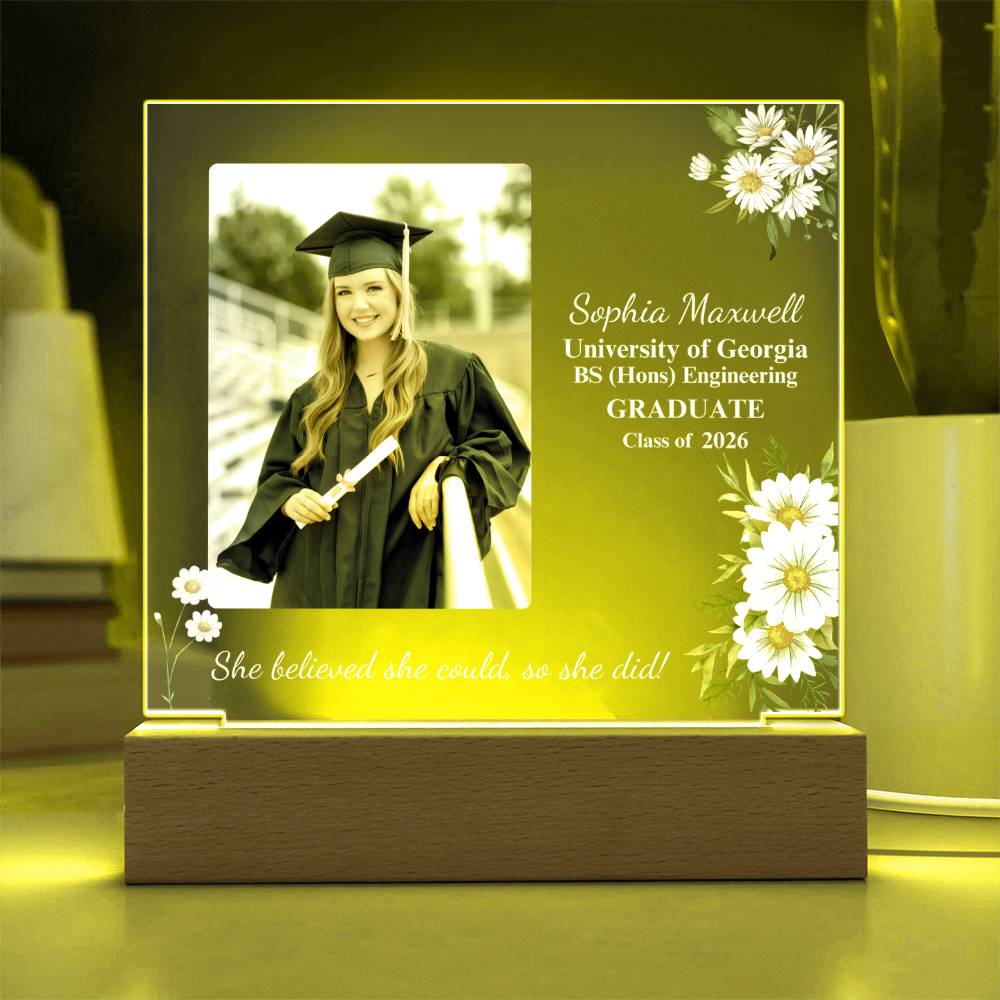 Graduation-themed photo frame with a graduate's picture and personalized text on a wooden base.